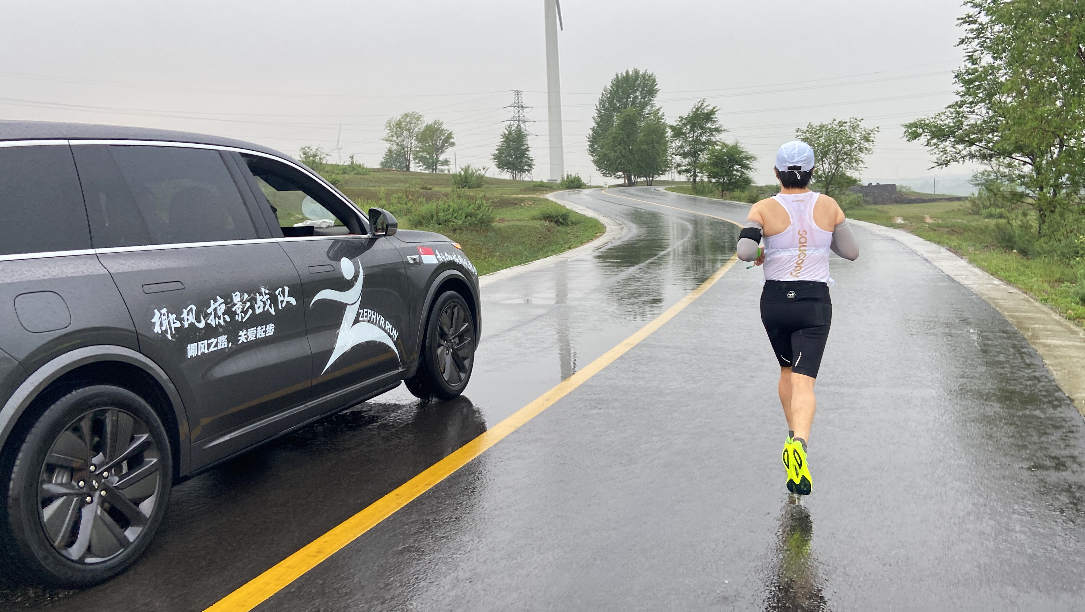 Zephyr runner on the road with team support car alongside